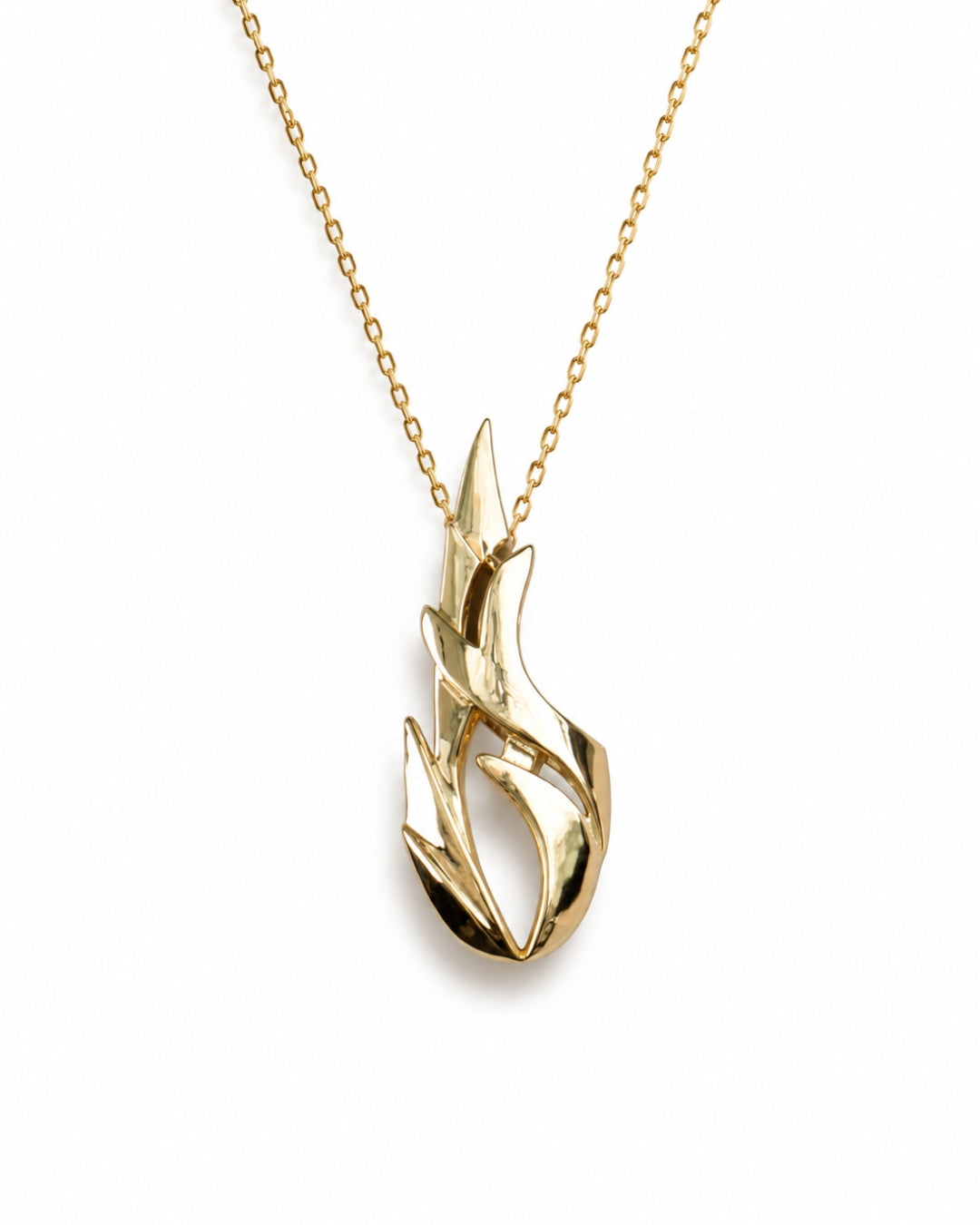 A gold necklace with a stylized flame-shaped pendant, shown against a plain white background.